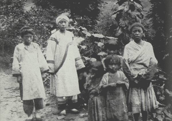 RATHER A RARE PICTURE OF TRIBES

Three tribes are shown: White Bones (left), attending her mistress, a
Nou-su aristocrat (Black Bones); the children at the right are Hua Miao.